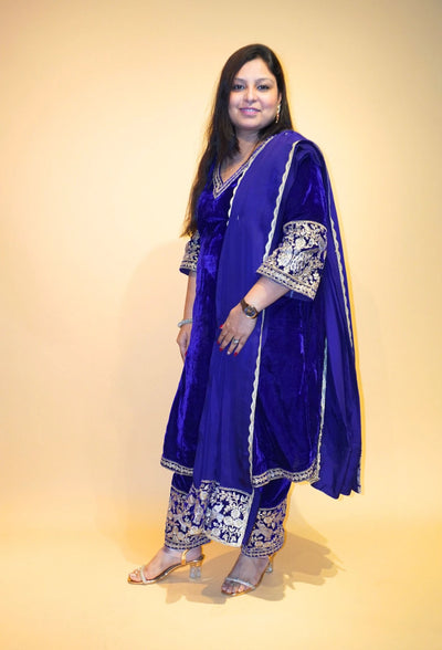 Velvet Majesty by Destiny by Anjali exudes luxury with premium velvet fabric and golden embroidery on the handcuffs and hem. Available in Royal Blue, Ebony Black, and Maroon, this elegant suit is perfect for weddings and festive occasions.&nbsp;