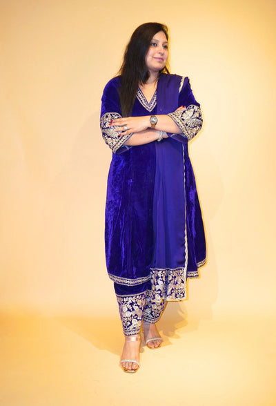 Velvet Majesty by Destiny by Anjali exudes luxury with premium velvet fabric and golden embroidery on the handcuffs and hem. Available in Royal Blue, Ebony Black, and Maroon, this elegant suit is perfect for weddings and festive occasions.&nbsp;