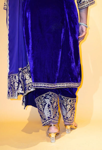 Velvet Majesty by Destiny by Anjali exudes luxury with premium velvet fabric and golden embroidery on the handcuffs and hem. Available in Royal Blue, Ebony Black, and Maroon, this elegant suit is perfect for weddings and festive occasions.&nbsp;