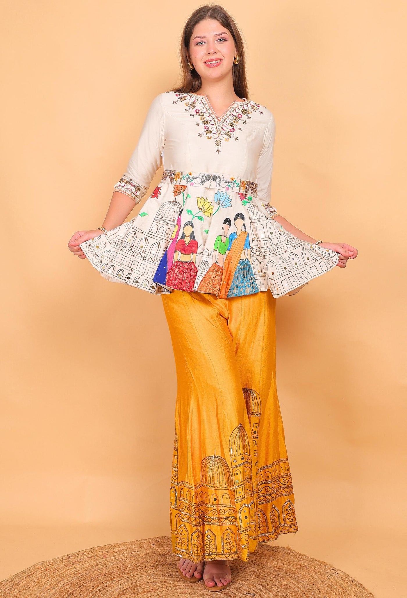 Woman wearing a colorful outfit with a patterned top and yellow pants on a beige background