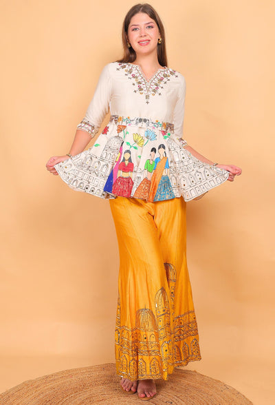Woman wearing a colorful outfit with a patterned top and yellow pants on a beige background