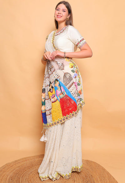 Woman wearing a traditional saree with a colorful border against a beige background