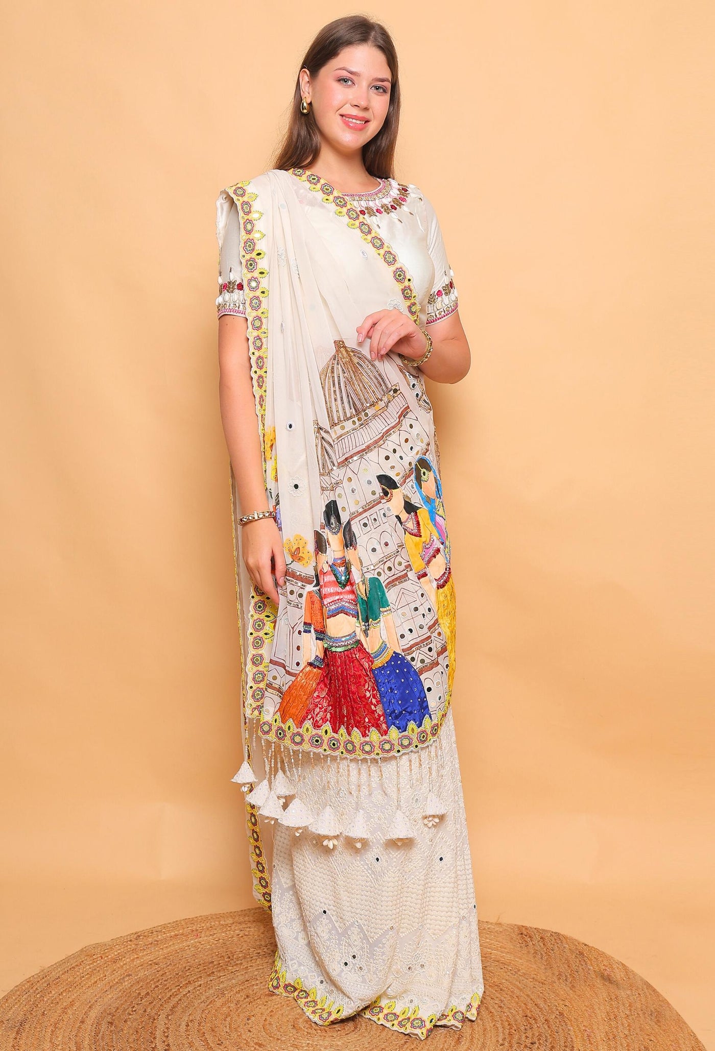 Woman wearing a traditional embroidered saree against a beige background