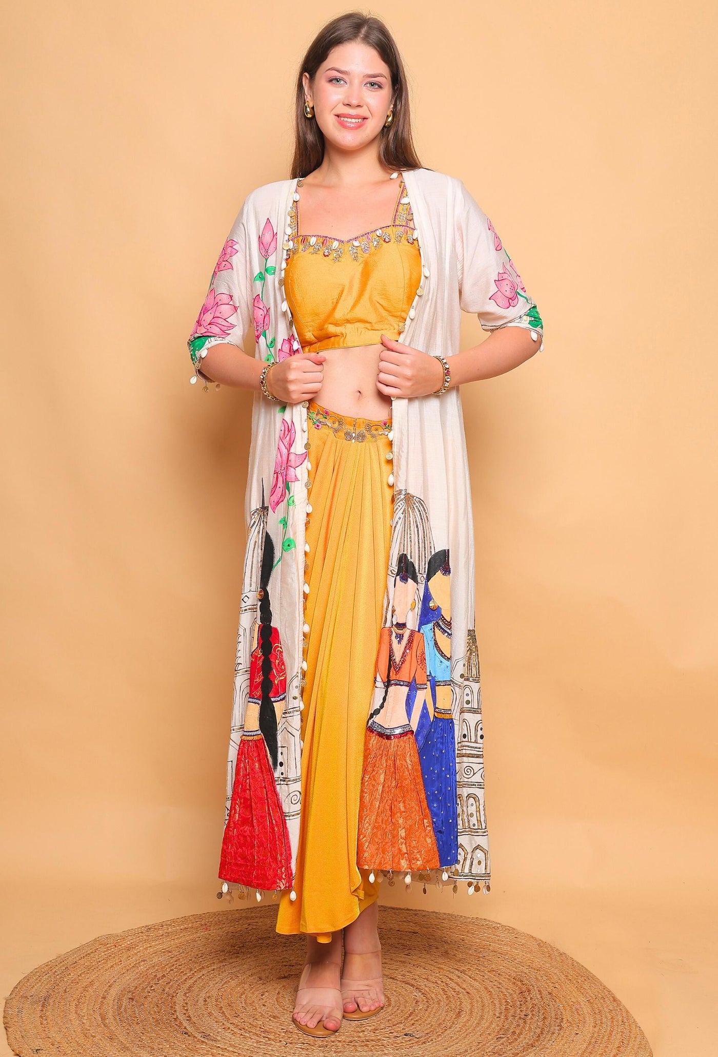 Woman wearing a mustard yellow outfit with a floral kimono-style jacket on a beige background