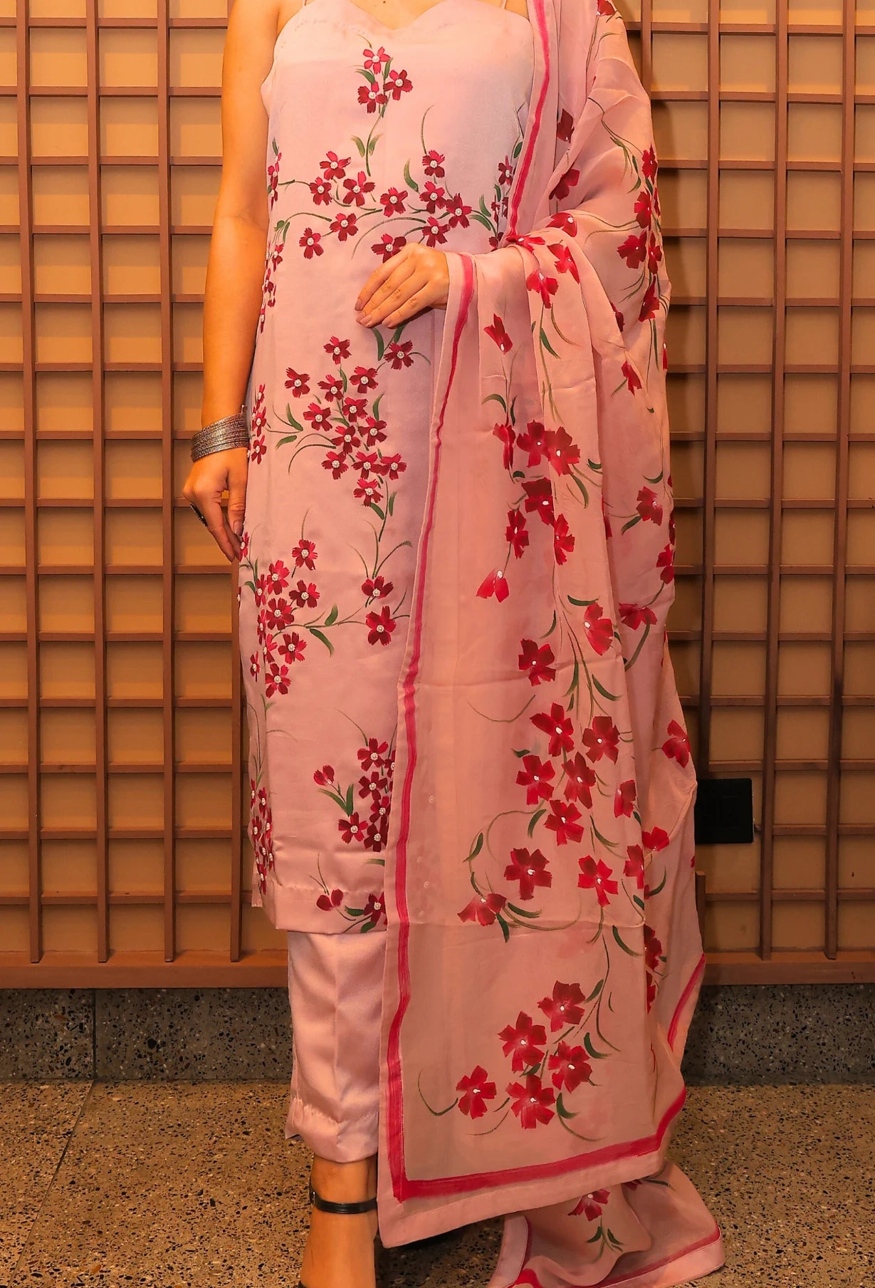 Experience the beauty of nature with Floral Desire. This hand painted and hand embroidered suit features a stunning floral design on imported armani satin fabric. With a delicate noodle strap neckline, this suit is a true masterpiece from designer brand Destiny by Anjali. Elevate your style and embrace the art of nature.